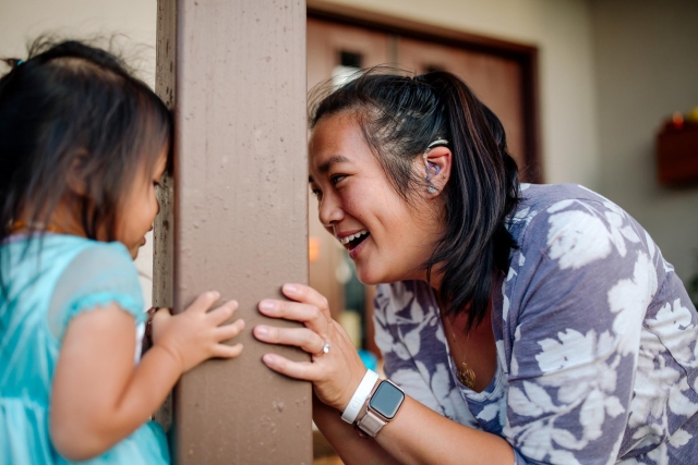 Asian woman and daughter playing
