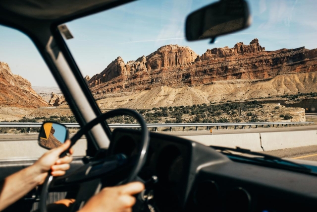 Hands on steering wheel in classic car
