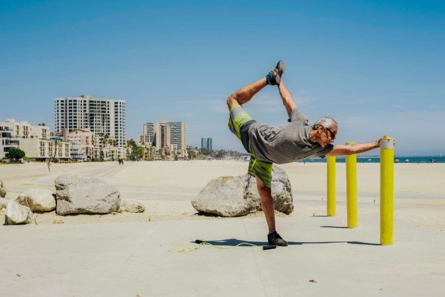 Older man exercising on beach