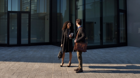 Colleagues meeting at the office entrance