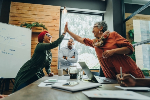 Colleagues giving each other high fives