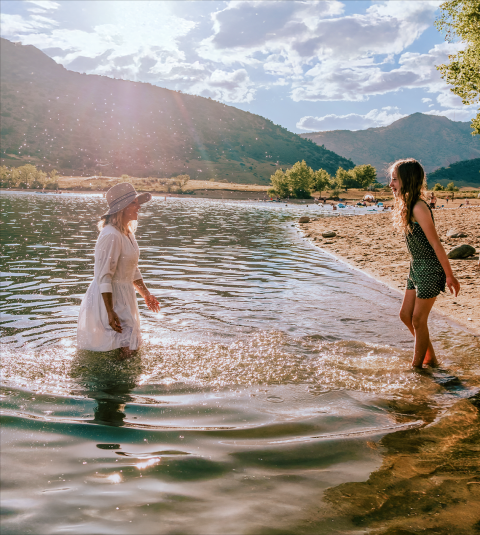 Mother and child playing in a lake
